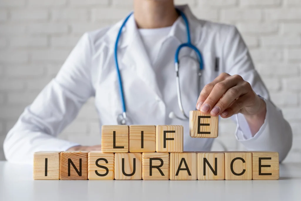 doctor-making-word-life-insurace-with-wooden-alphabet-blocks