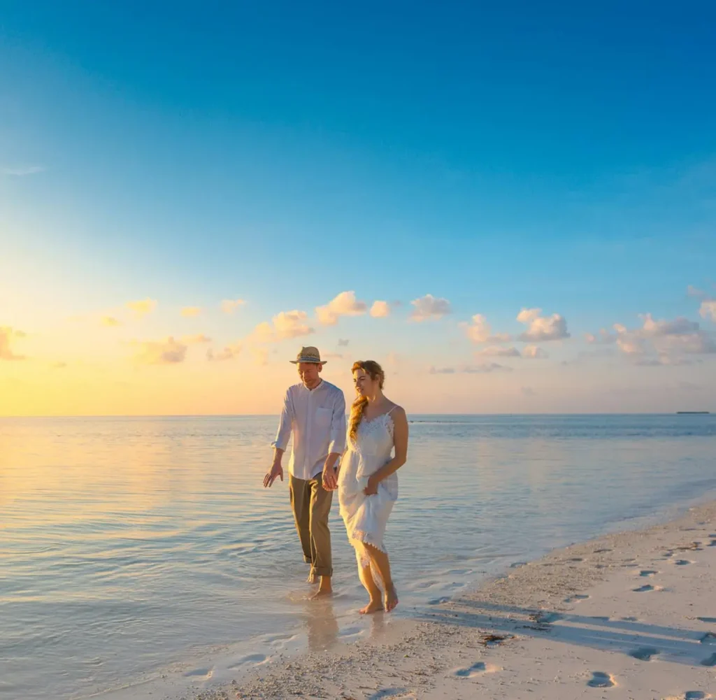 couple walking by beach talking about life insurance